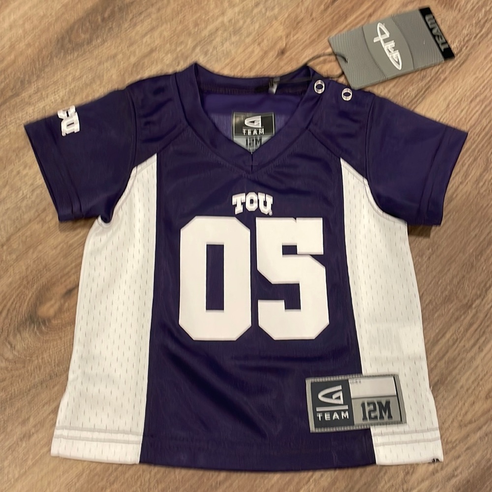 TCU football jersey. Never worn, tag still on. 12mo